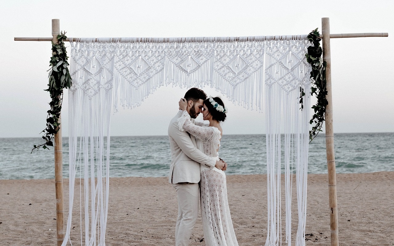 6 idee per organizzare un ricevimento di matrimonio perfetto. Coppia di sposi in spiaggia