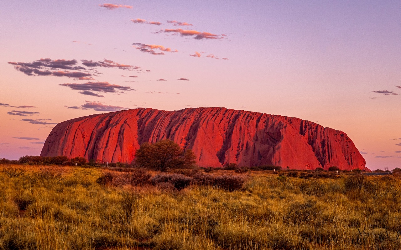 Pacchetto vacanze Australia. Vista sul masso roccioso di Uluru.
